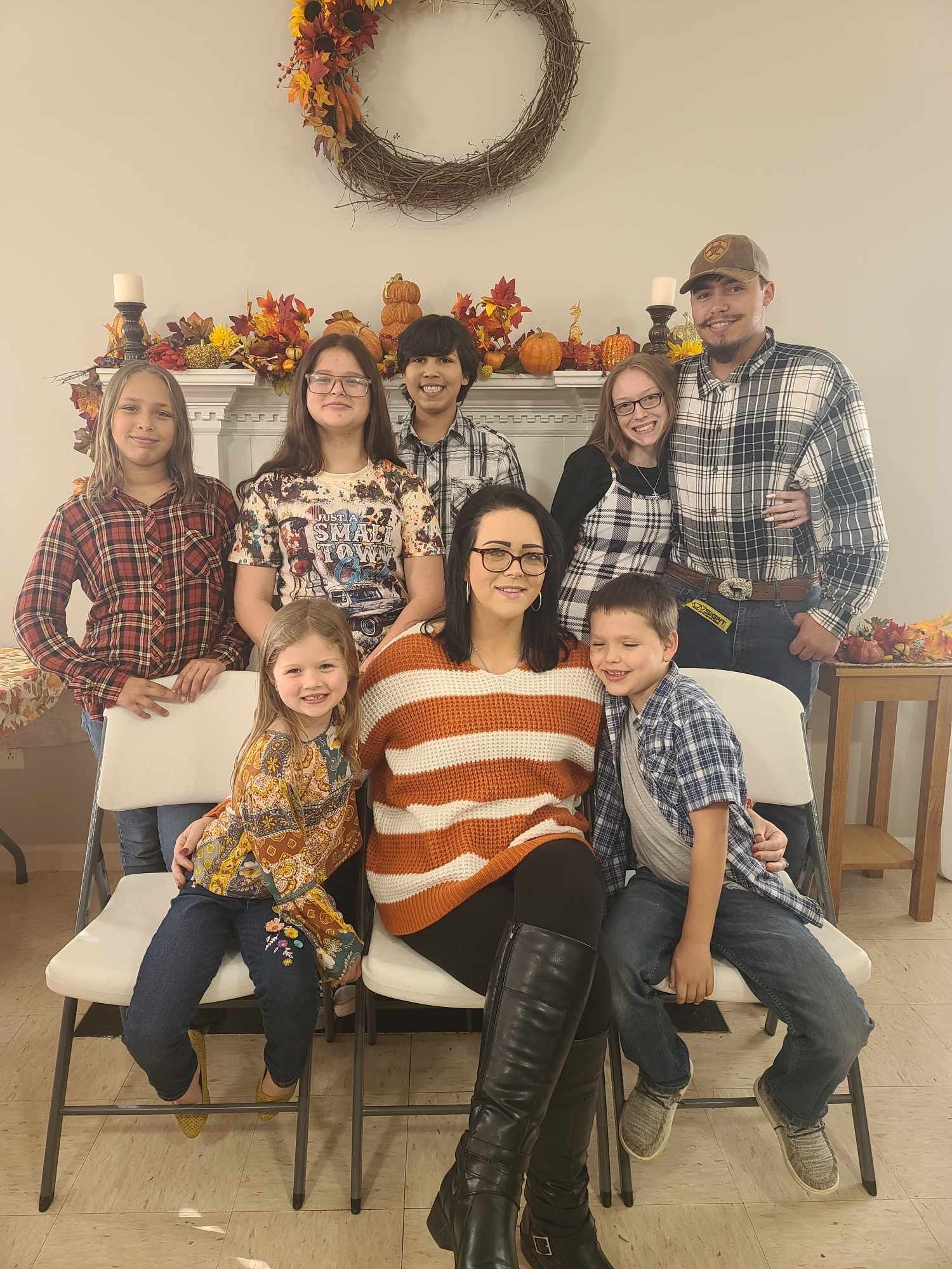 A group of people are posing for a picture in a living room.