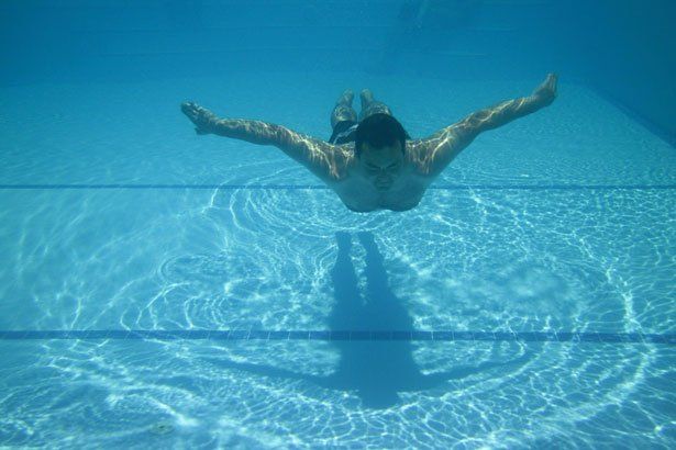 A Man Swimming in the Clear Blue Pool — Summerville, SC — Clearblue Pools