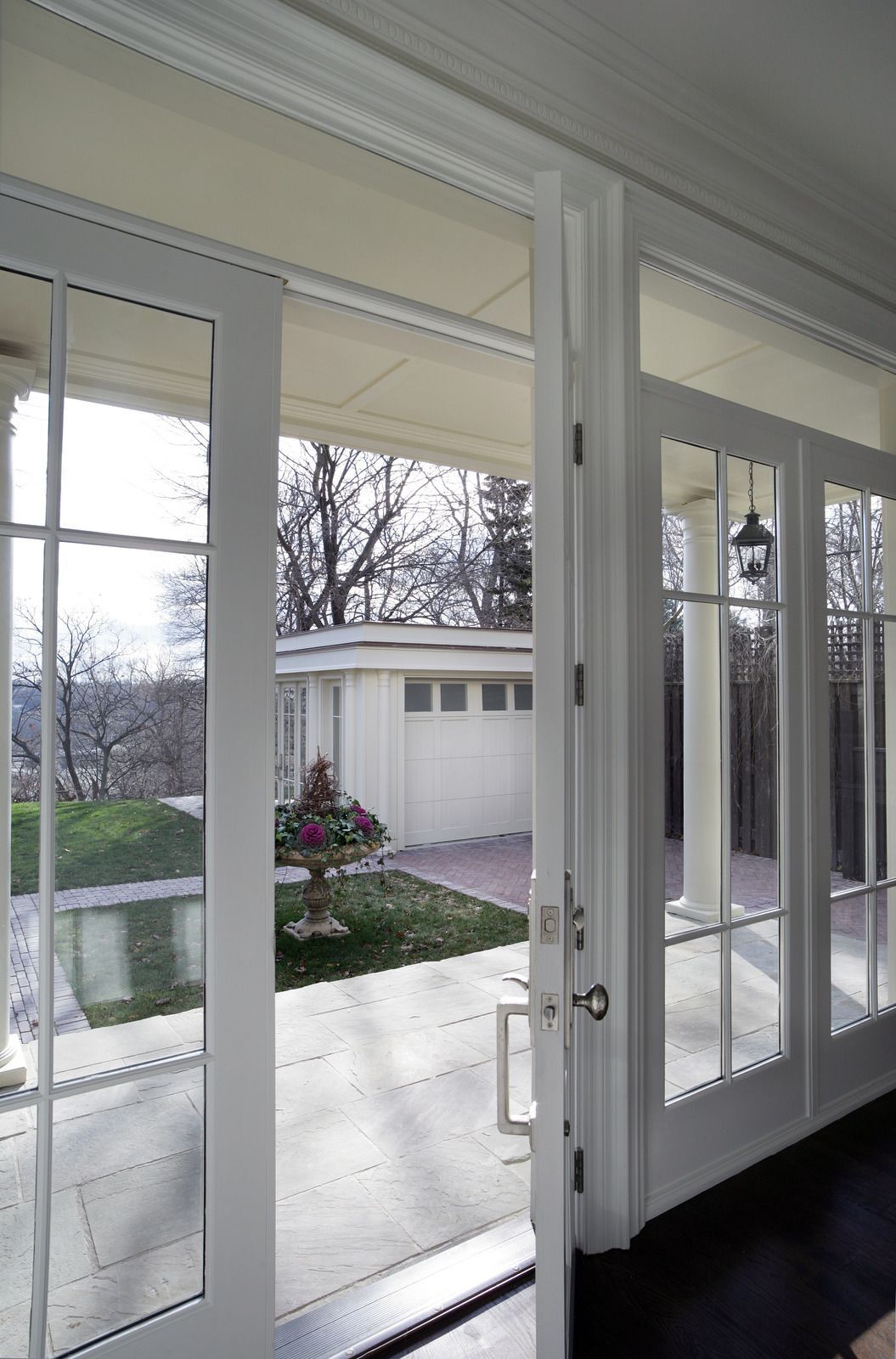 Modern office space with desks and computers facing large windows overlooking a city skyline.