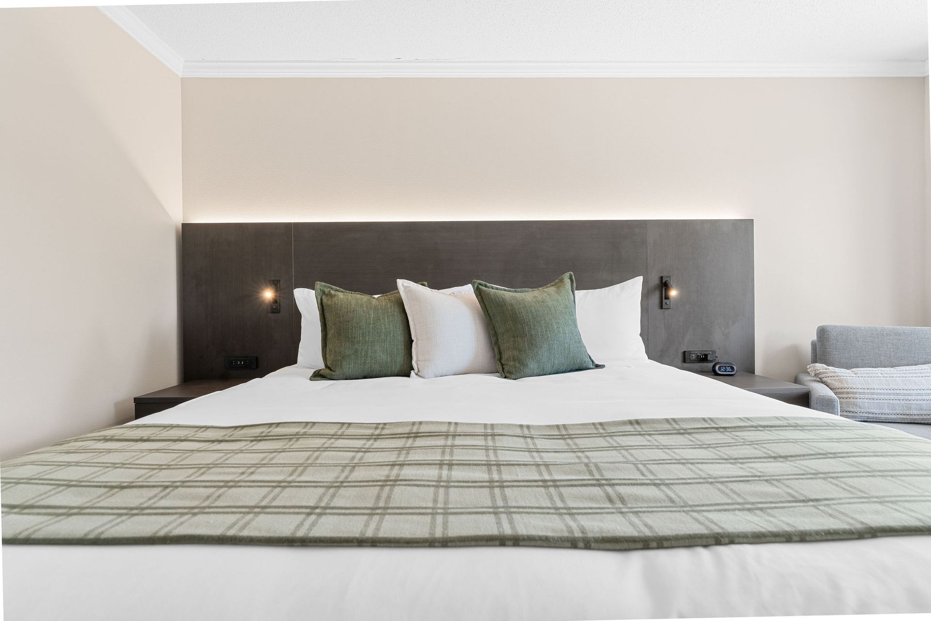 A hotel room with a king size bed and a couch