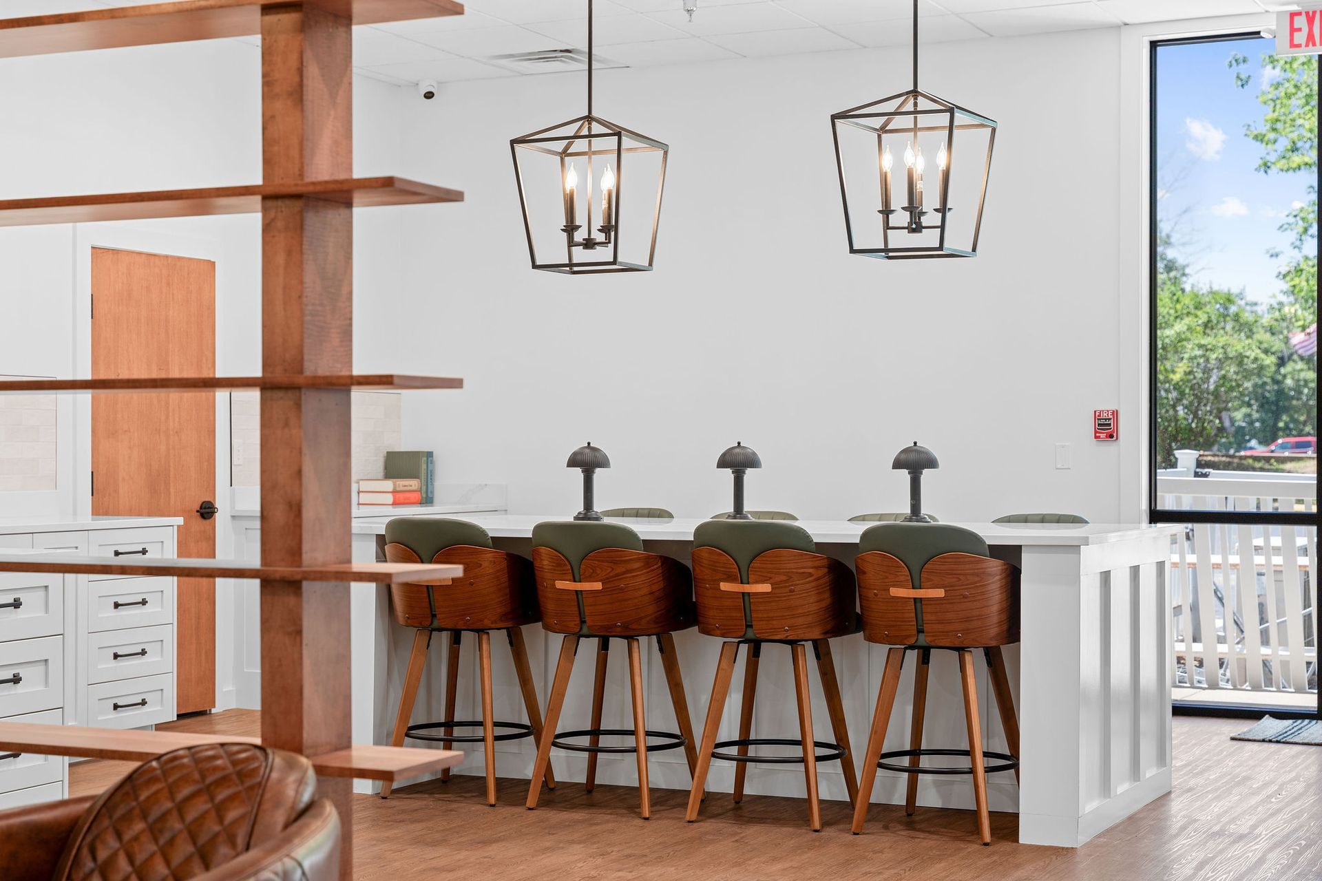A room with a bar and stools in it