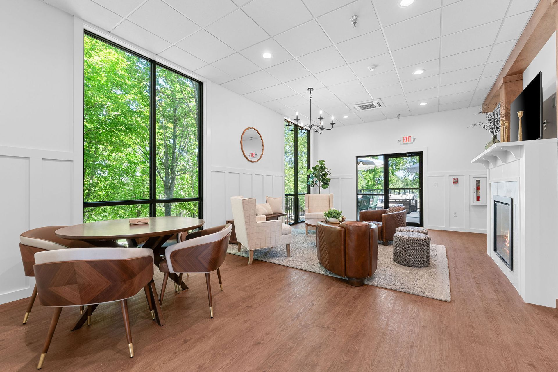 A living room with a table , chairs , and a fireplace.