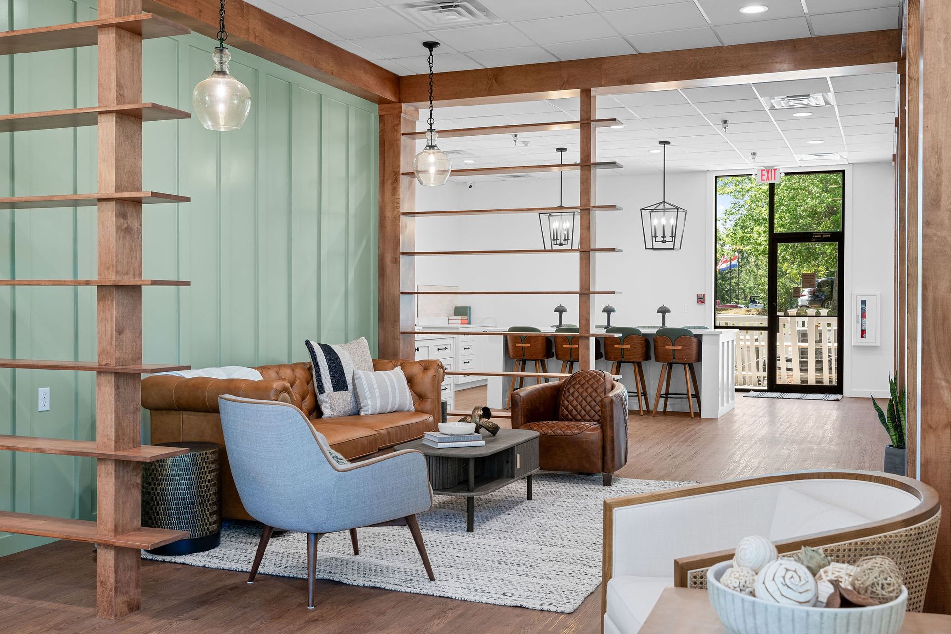 A living room with a couch , chairs , and a coffee table.