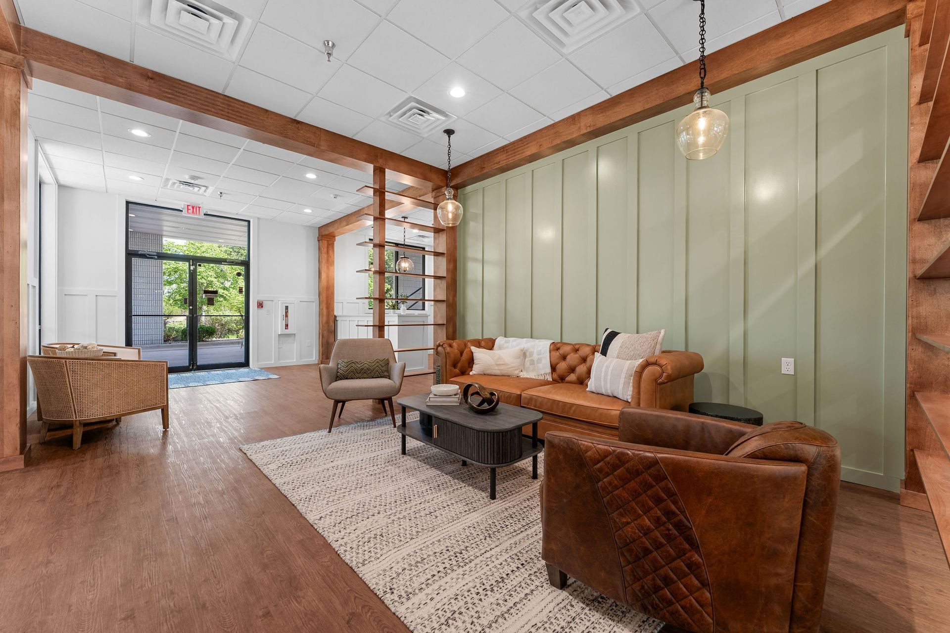 A living room with a couch , chairs , and a coffee table.