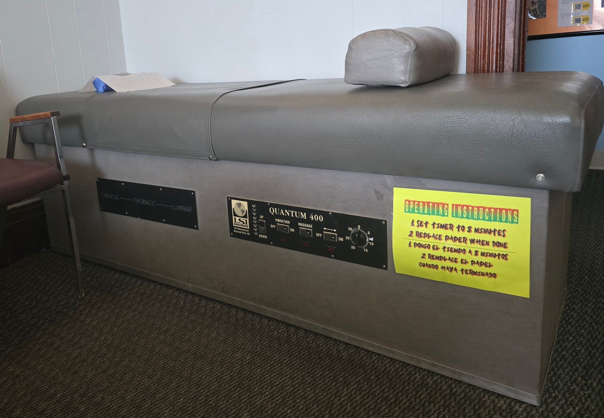 A massage table with a yellow sign on it