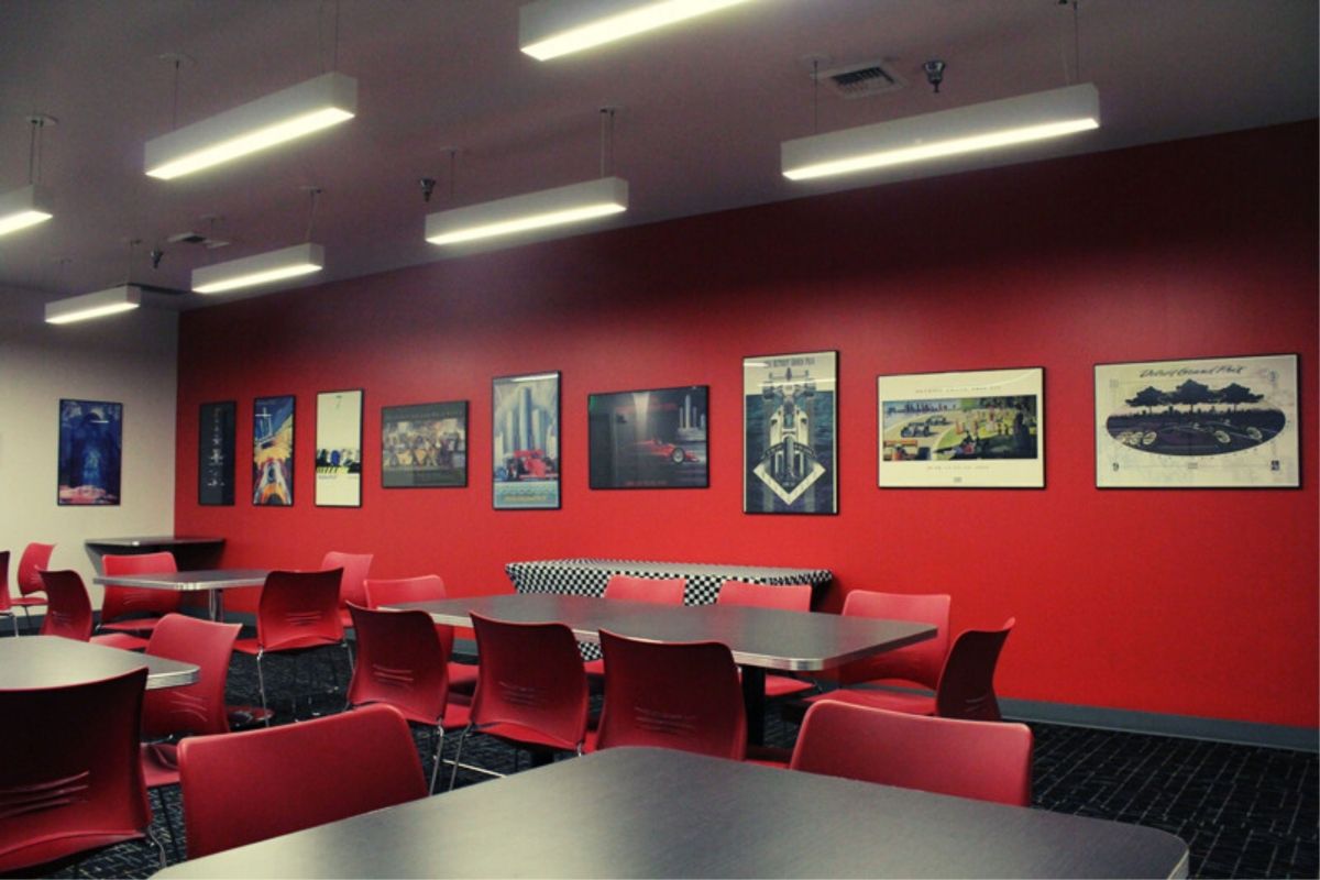 A dining room with tables and chairs and pictures on the wall.