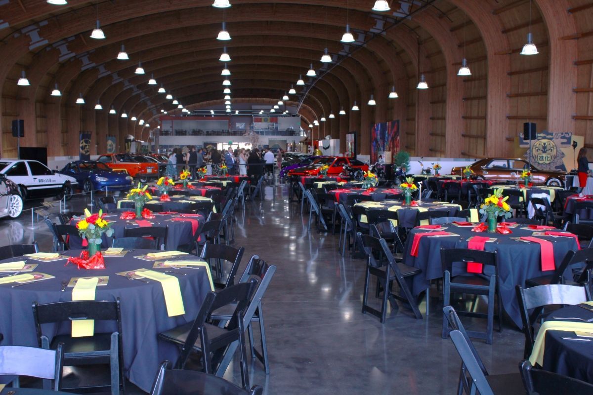 A large room with tables and chairs set up for a party