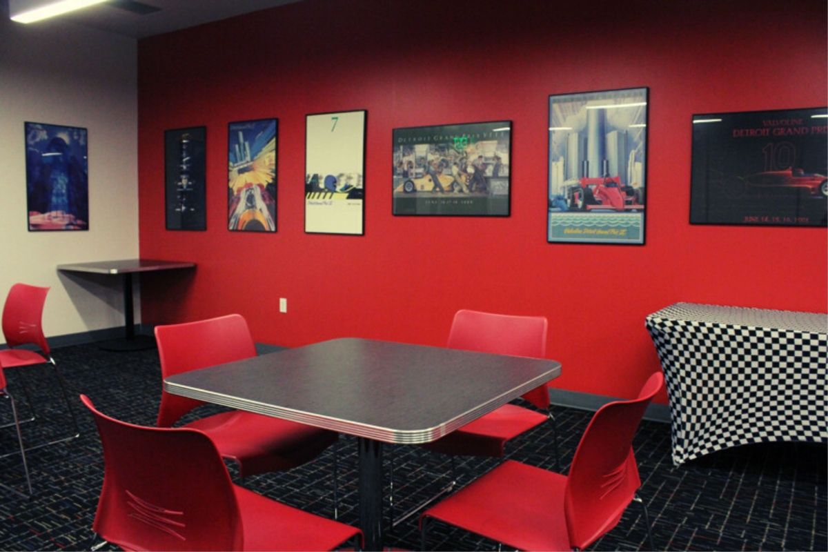 A table and chairs in a room with red walls