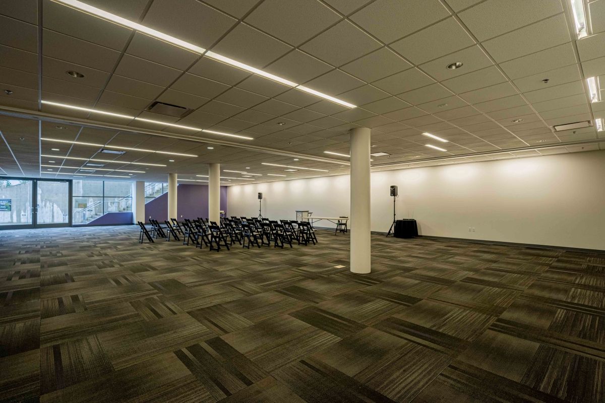 A large empty room with a lot of chairs in it.