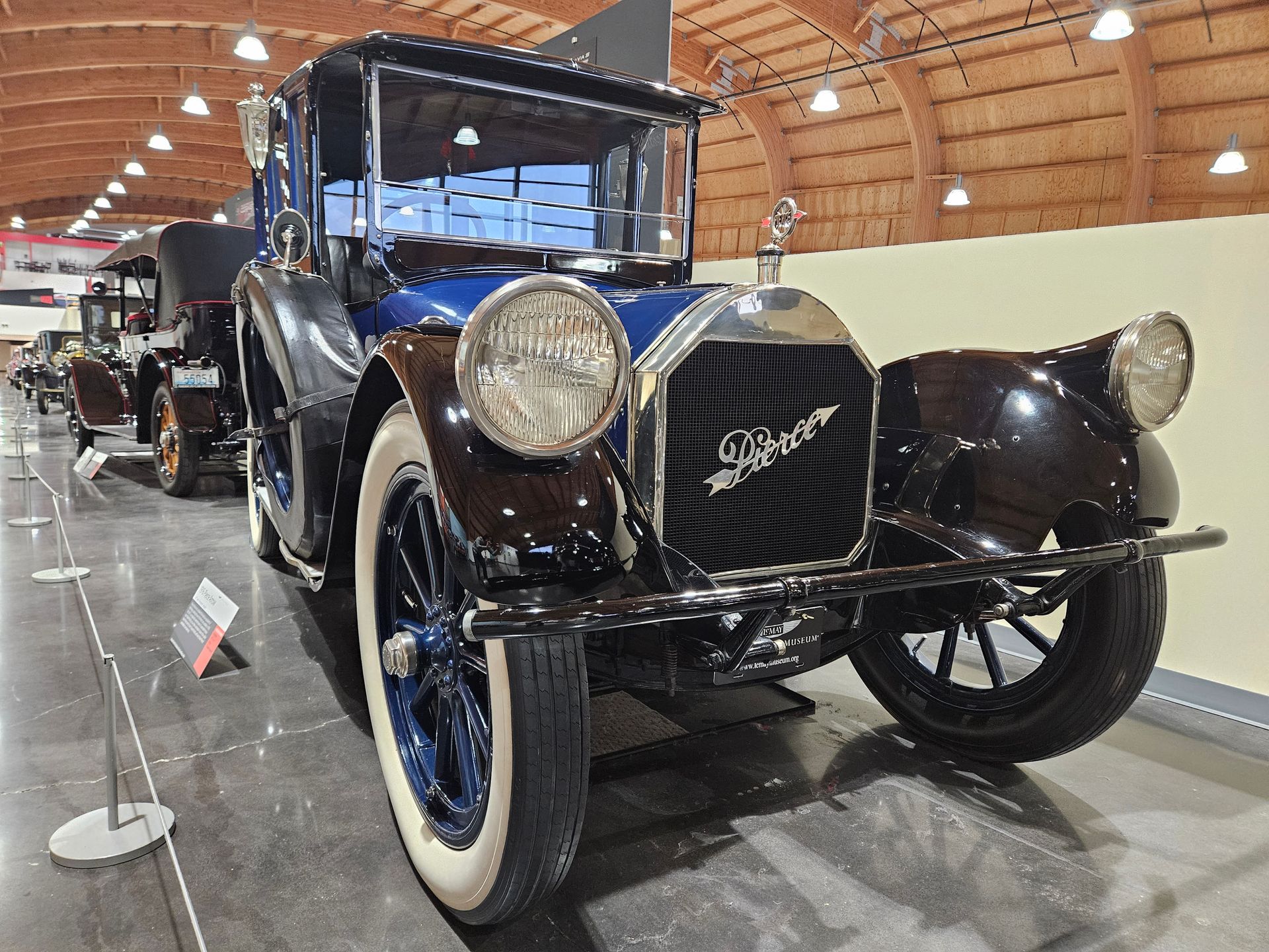 An old car is on display in a museum.