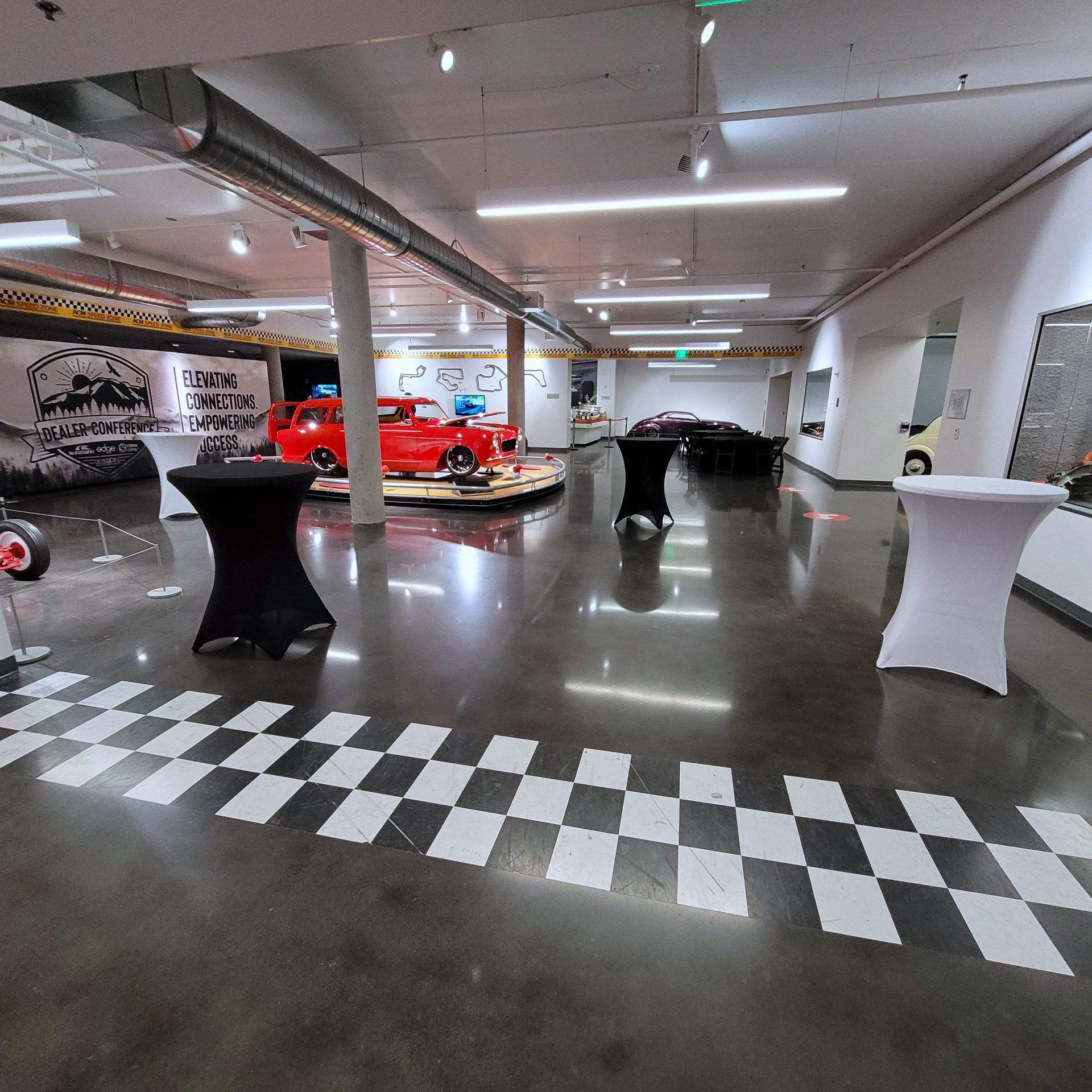 A large room with a checkered floor and tables