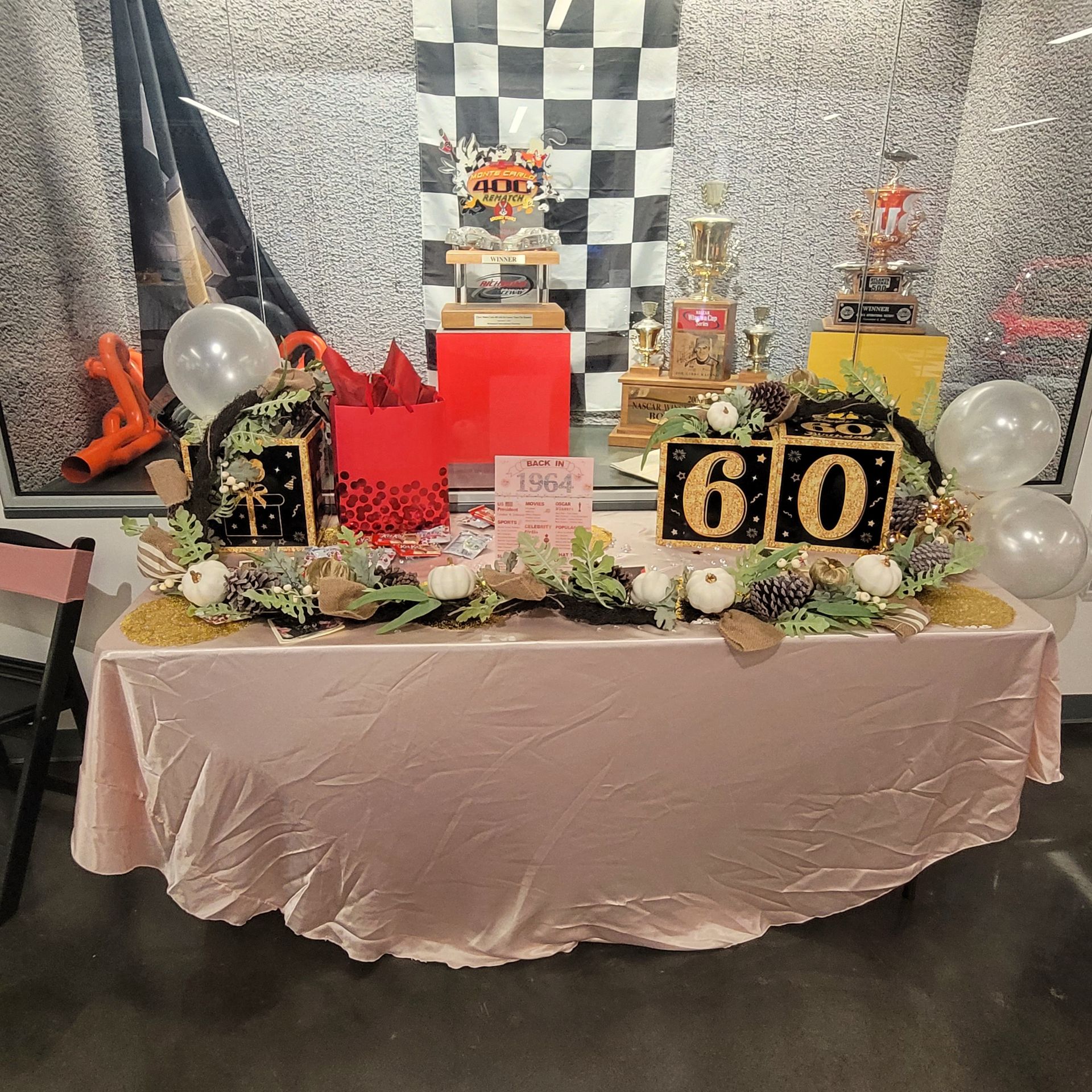 A table decorated for a 60th birthday party with balloons and flowers.