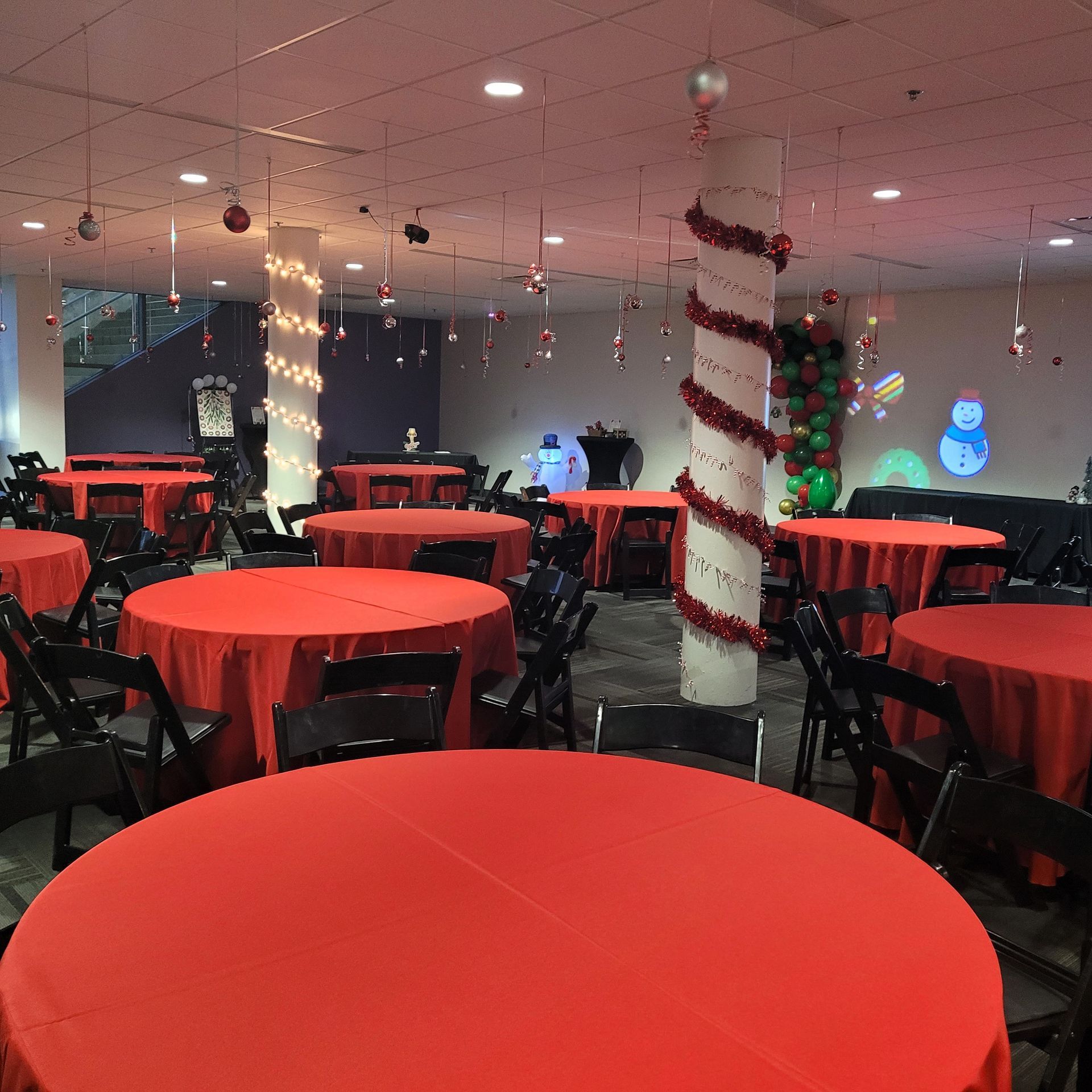 A large room with red tables and chairs