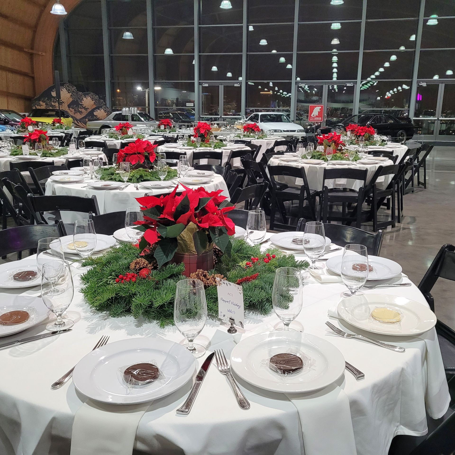 A large room with tables and chairs set up for a banquet