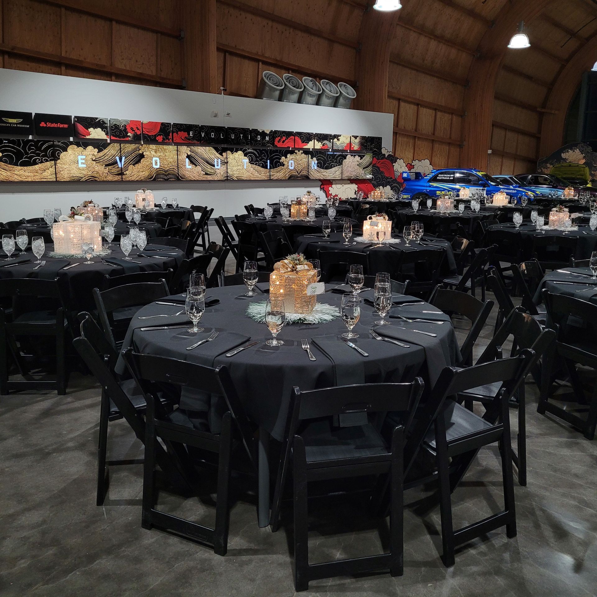 A large room with tables and chairs set up for a party