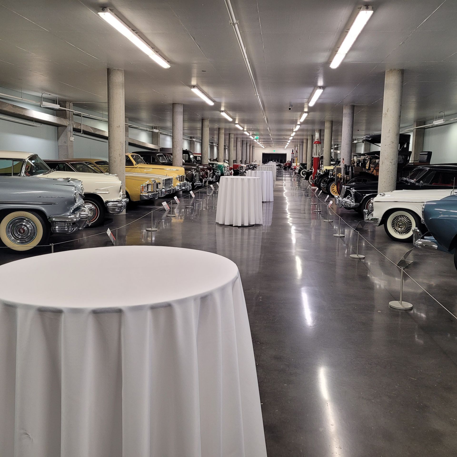 A large room filled with lots of cars and tables
