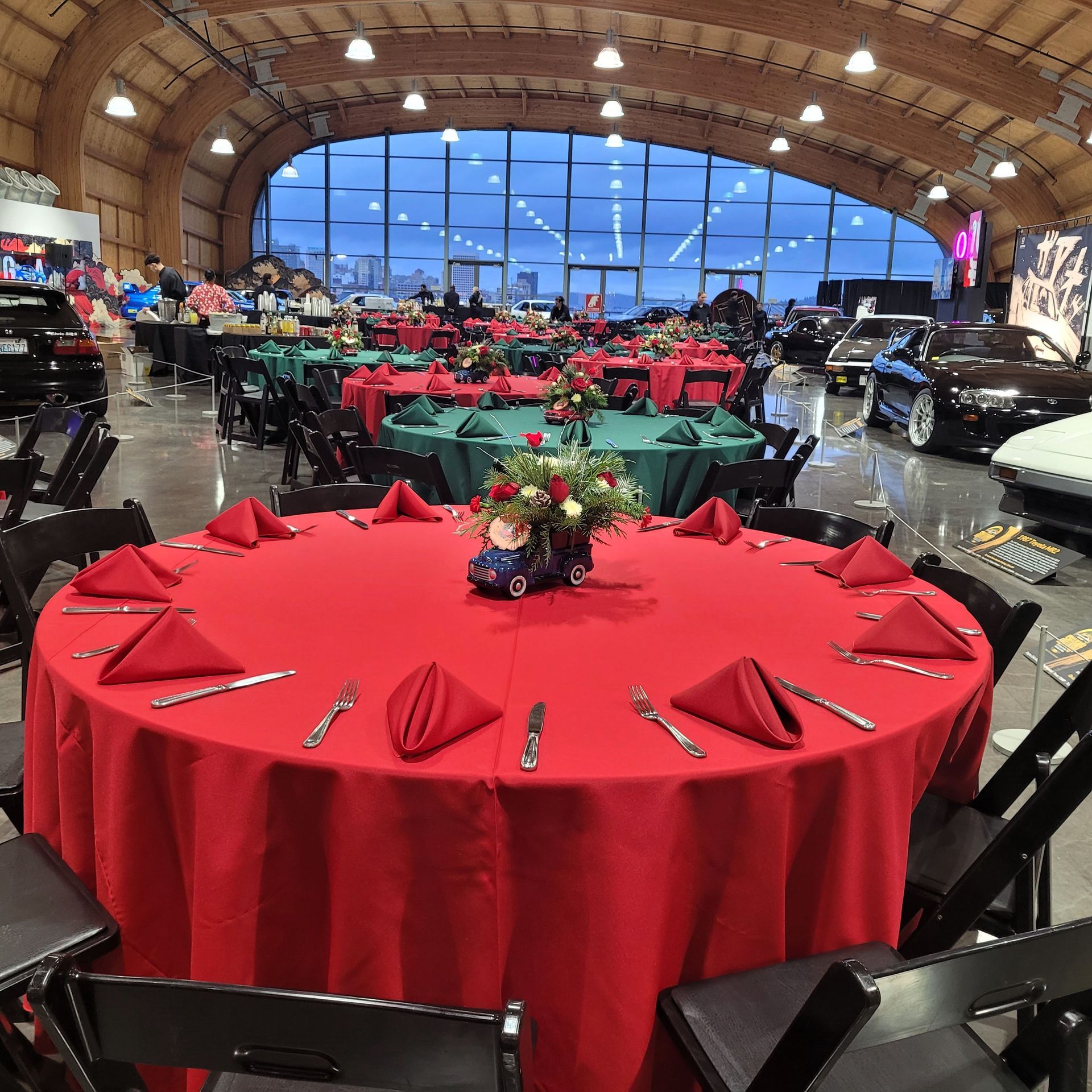 A large room with tables and chairs and a red table cloth