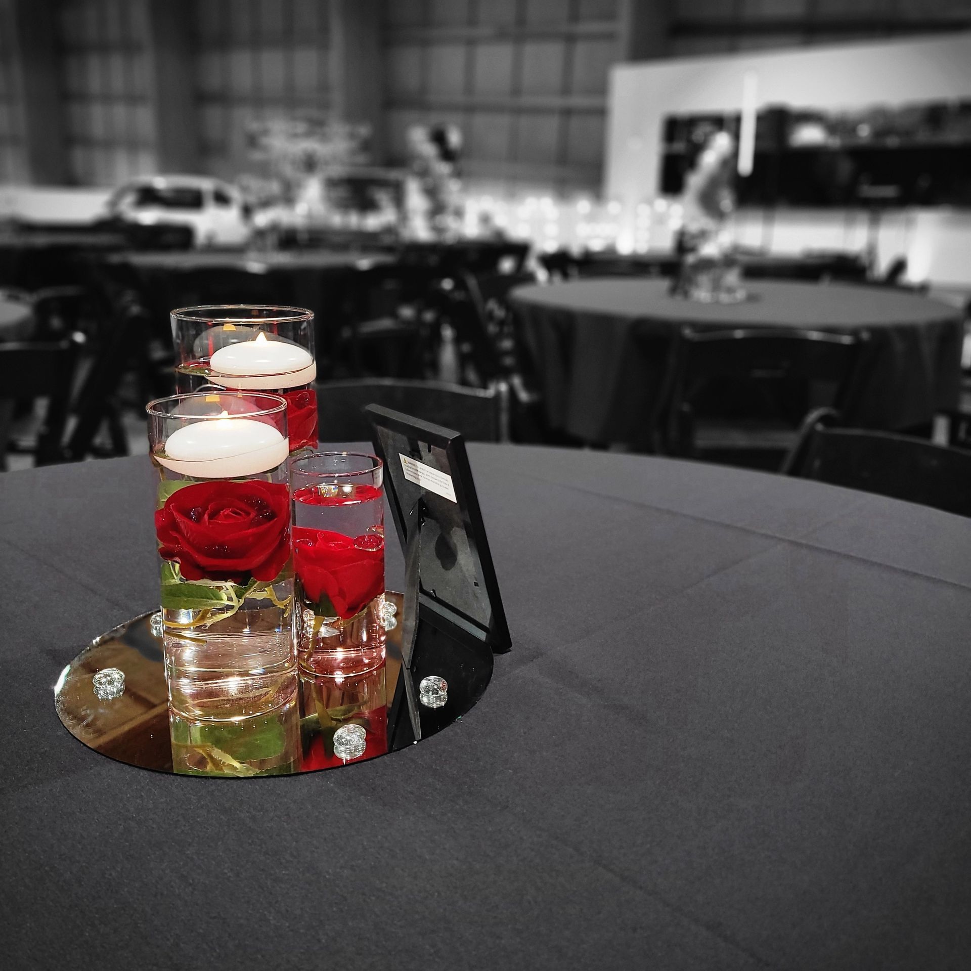A table with a vase of flowers and candles on it