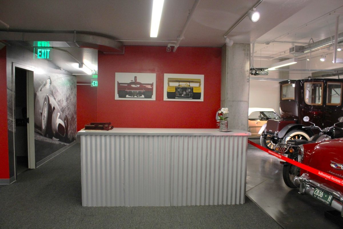 A room with a red wall and a green exit sign