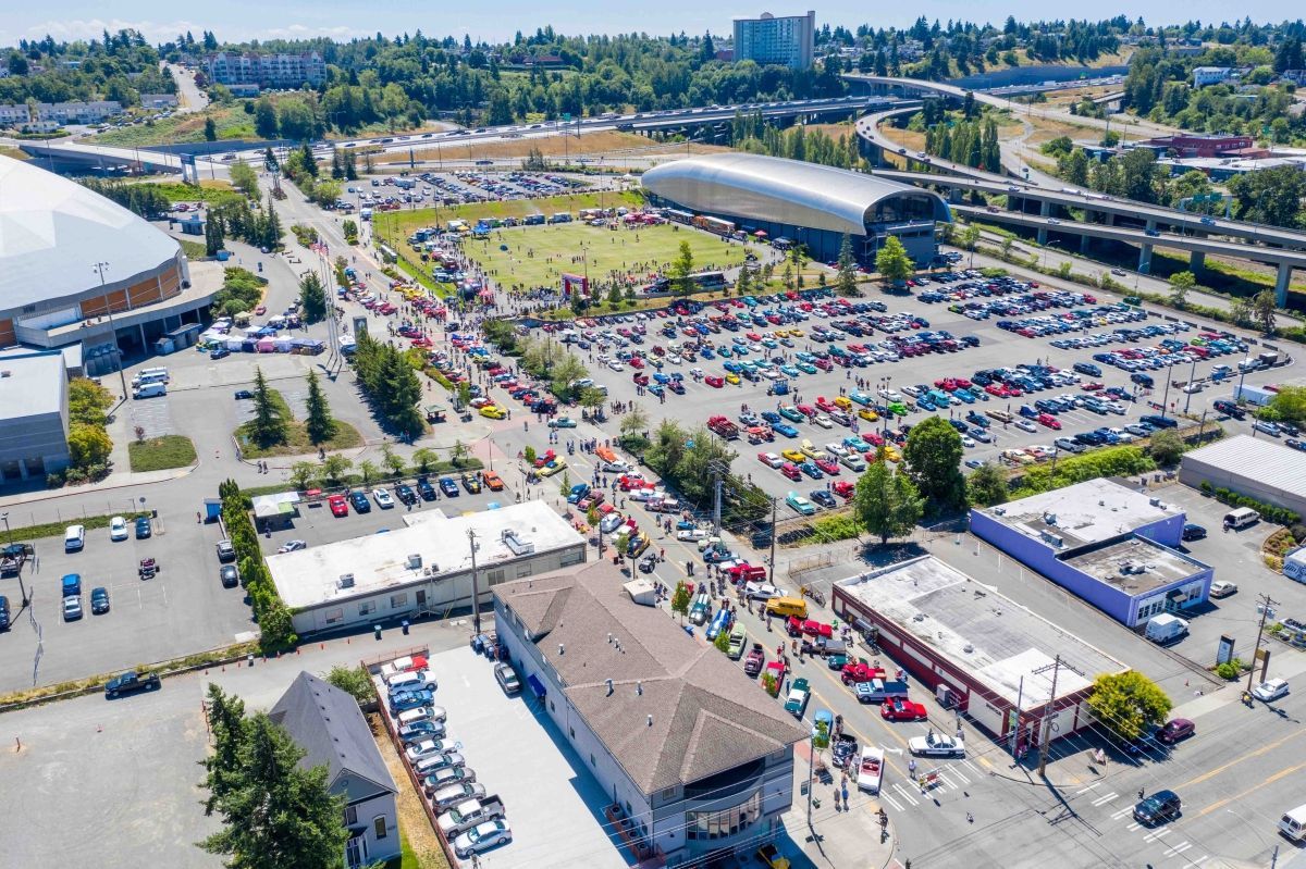 An aerial view of a parking lot filled with cars.