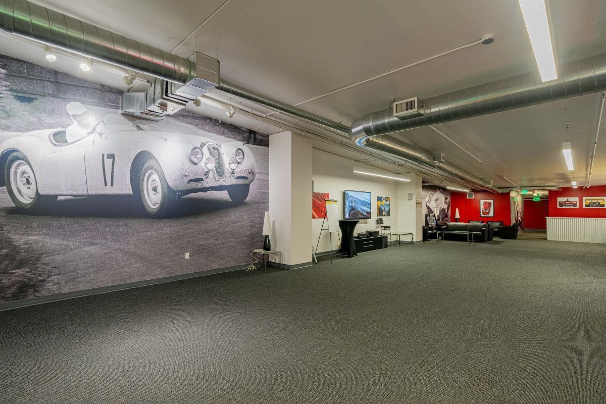 A large room with a picture of a race car on the wall.