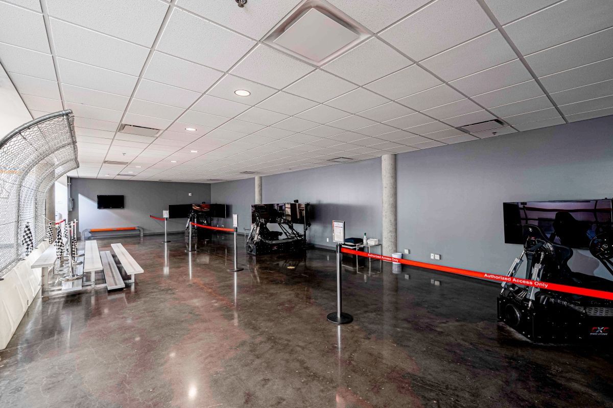 A large room with a ceiling and a concrete floor.