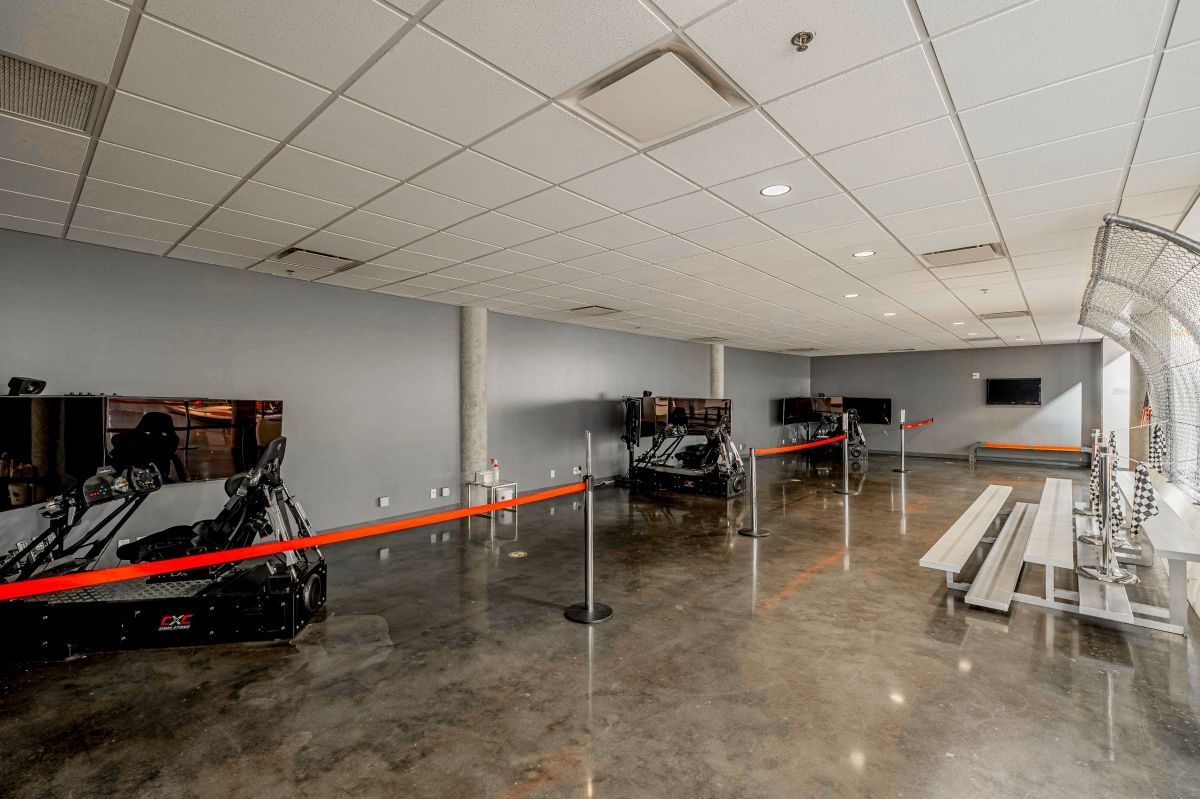 A large empty room with a concrete floor and a ceiling.