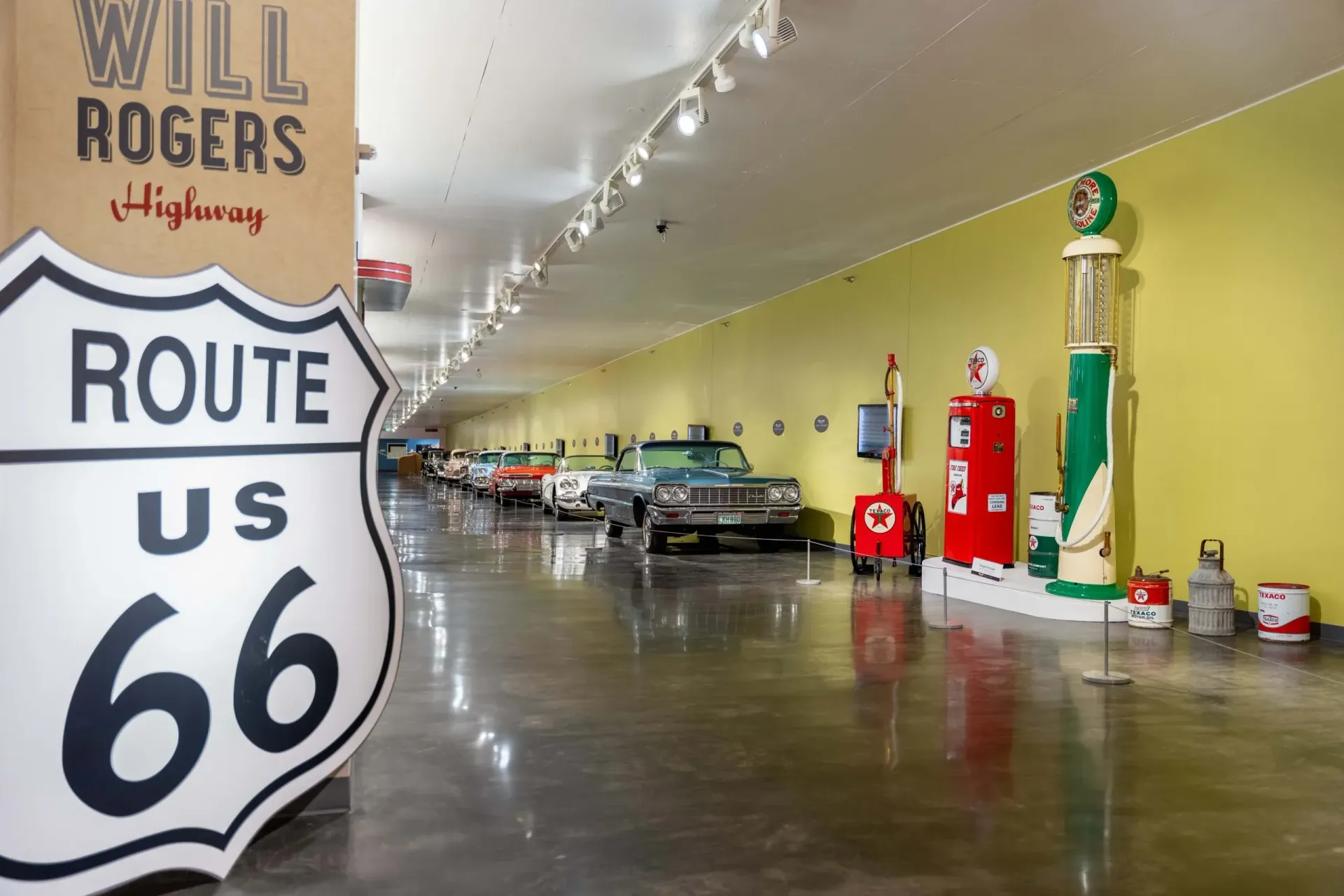 A large route 66 sign is in a museum
