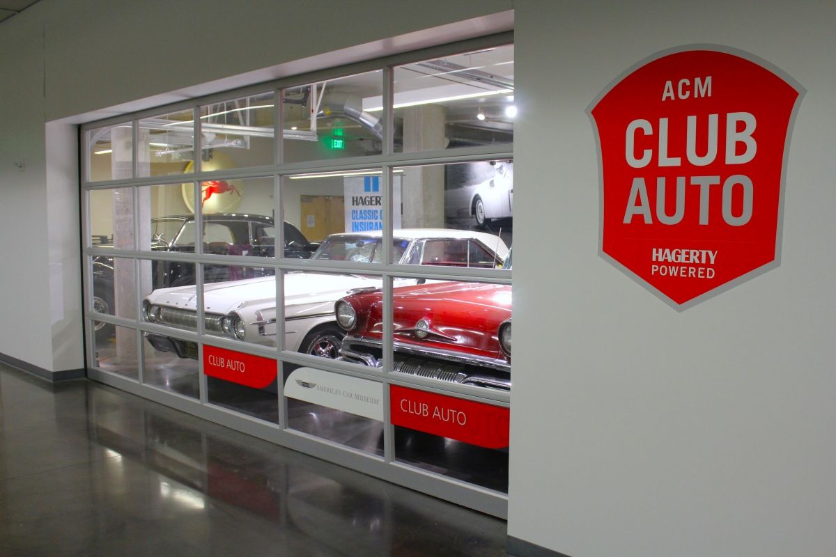 A red sign that says acm club auto on it