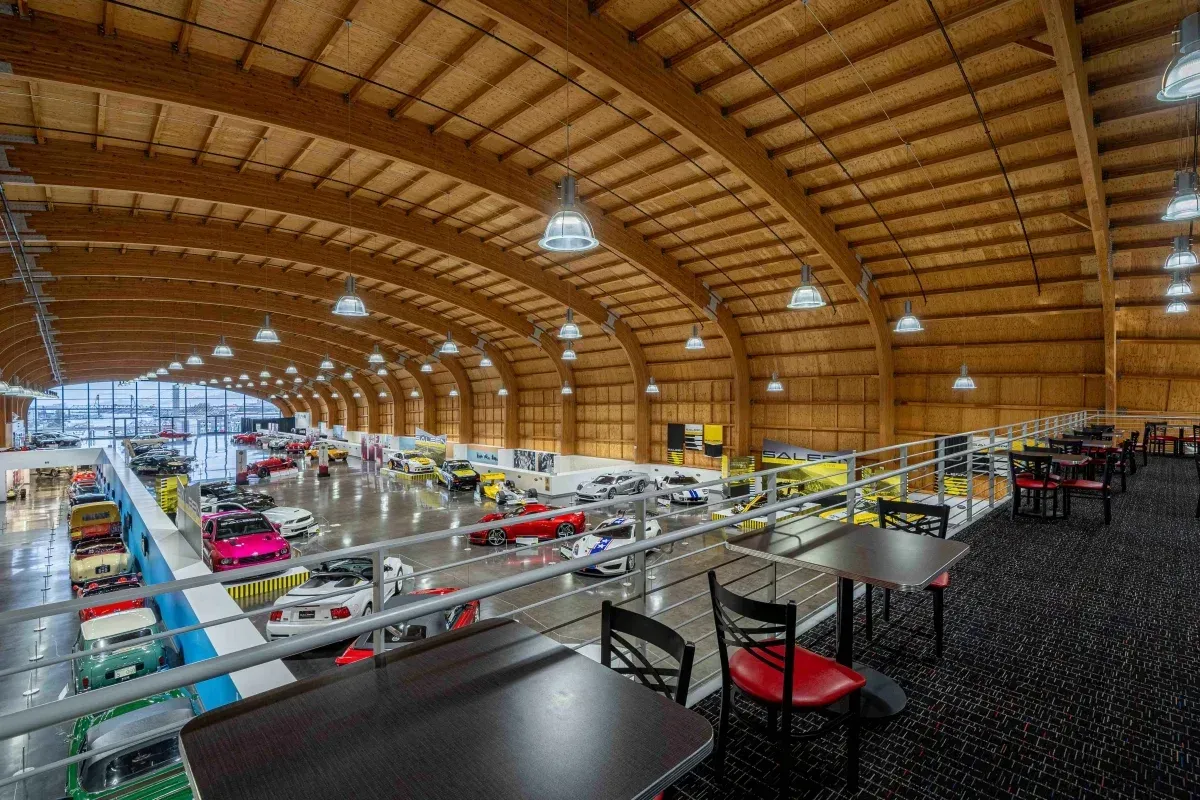 A large building with tables and chairs inside of it.