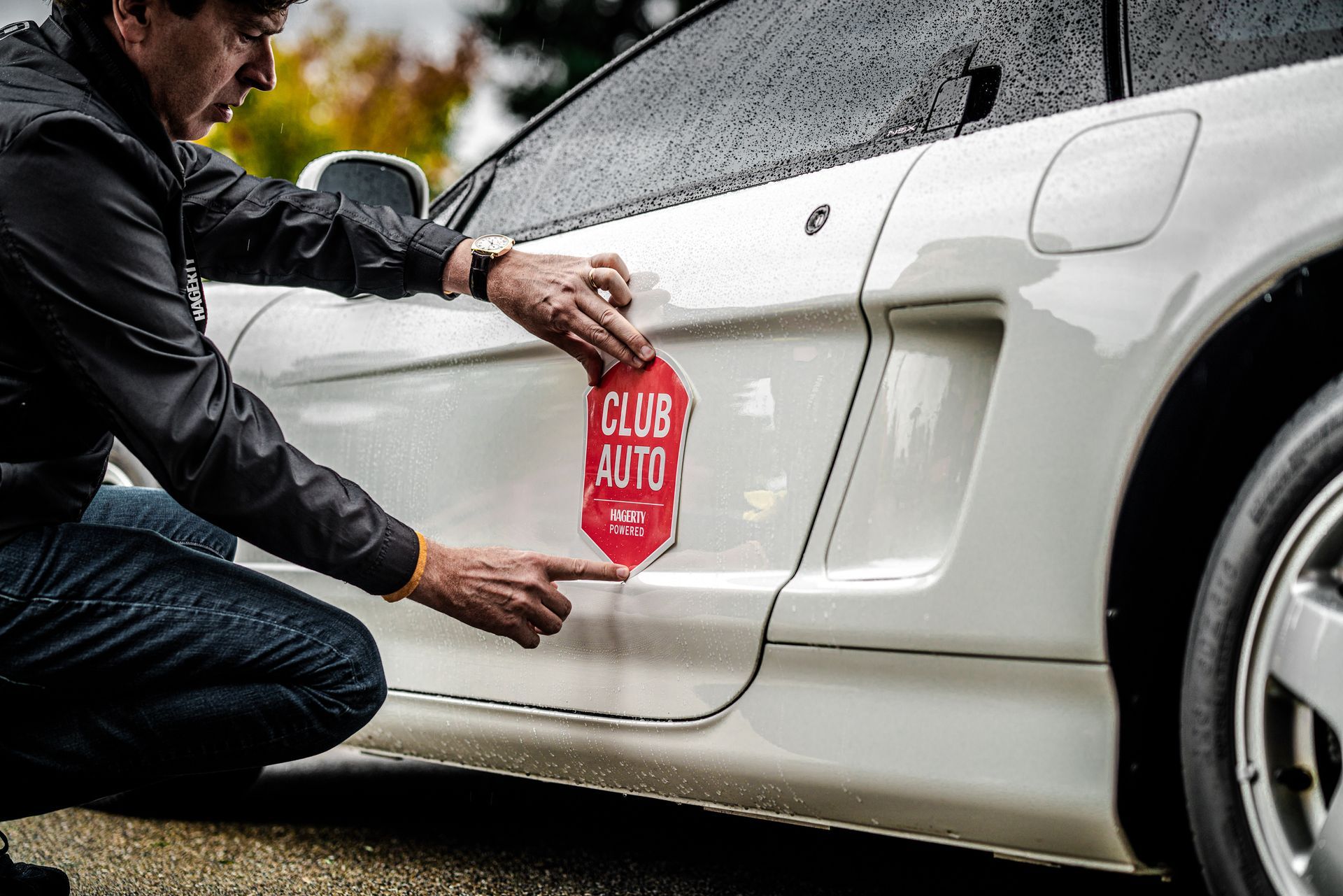 A row of porsche cars are parked in a parking lot