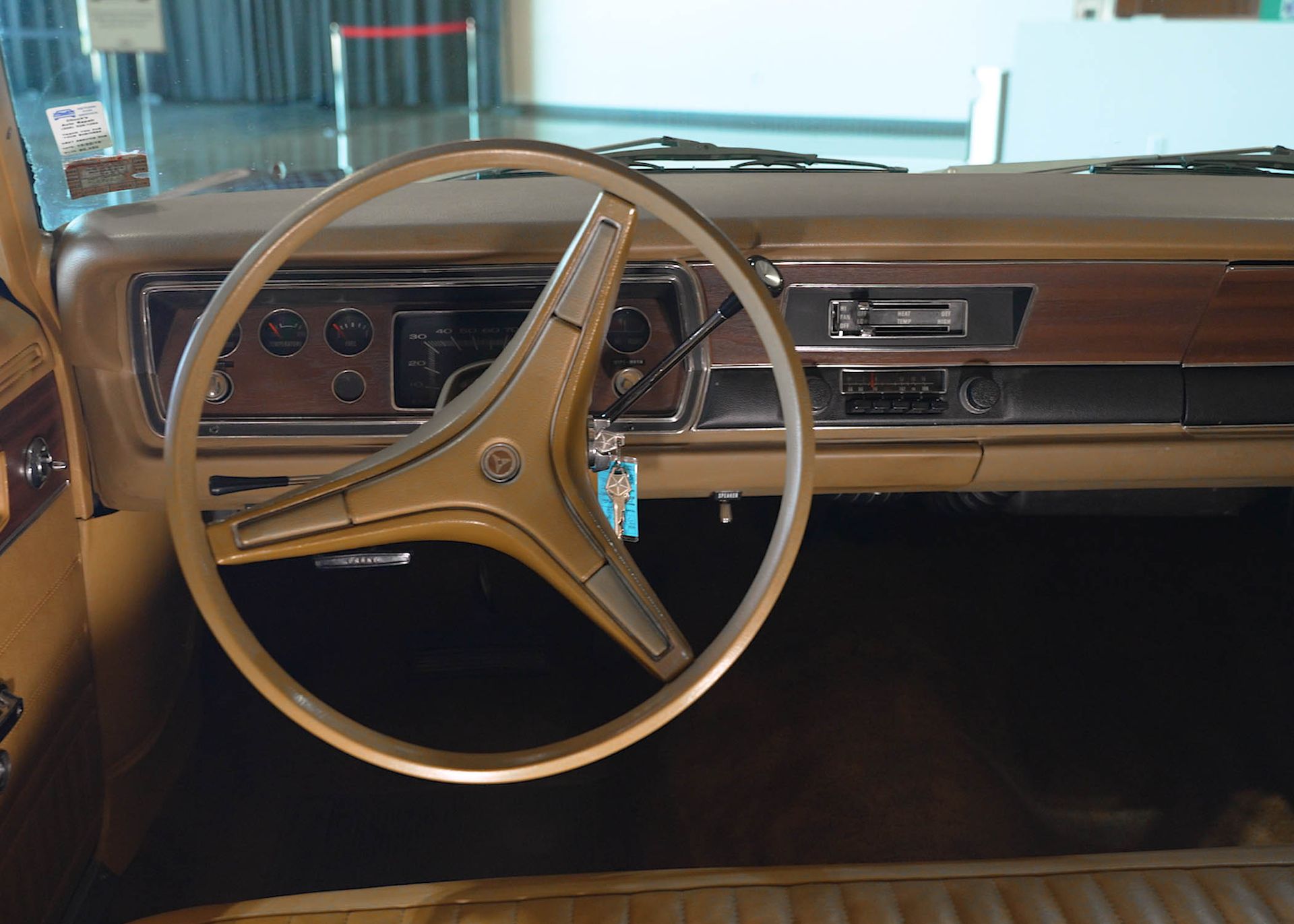 A close up of a car dashboard with a steering wheel