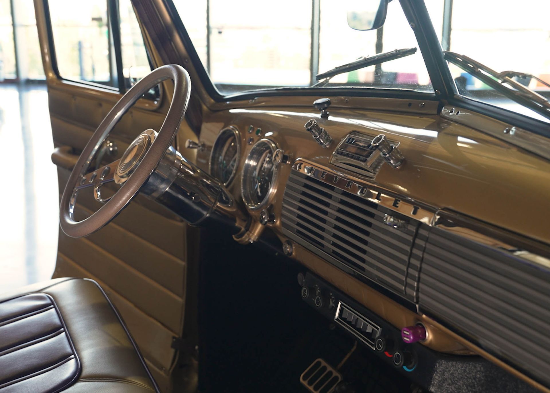 A close up of a car dashboard with a steering wheel