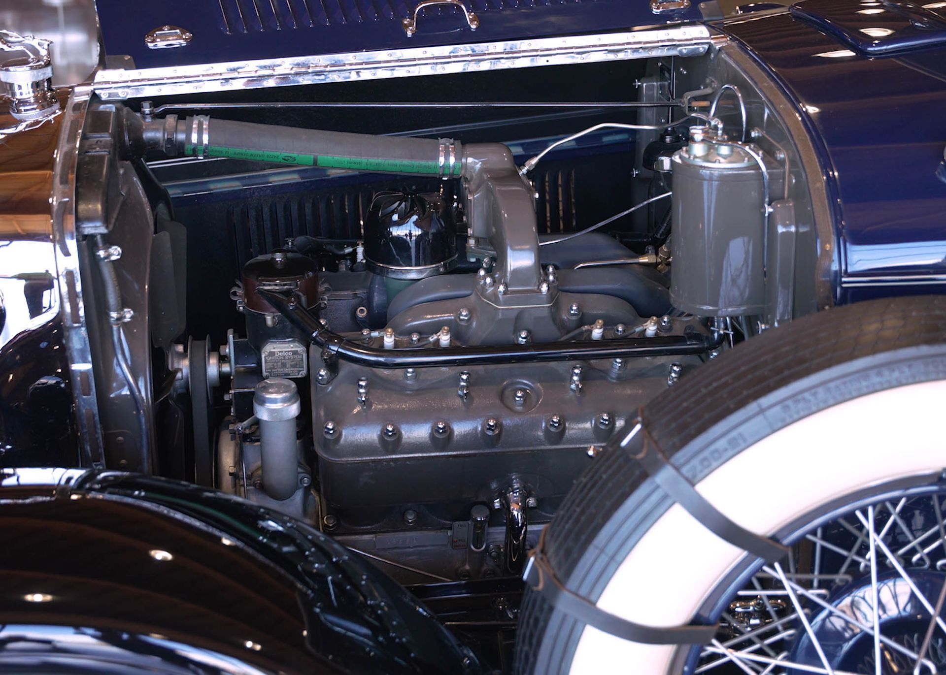 A close up of a car engine with the hood open