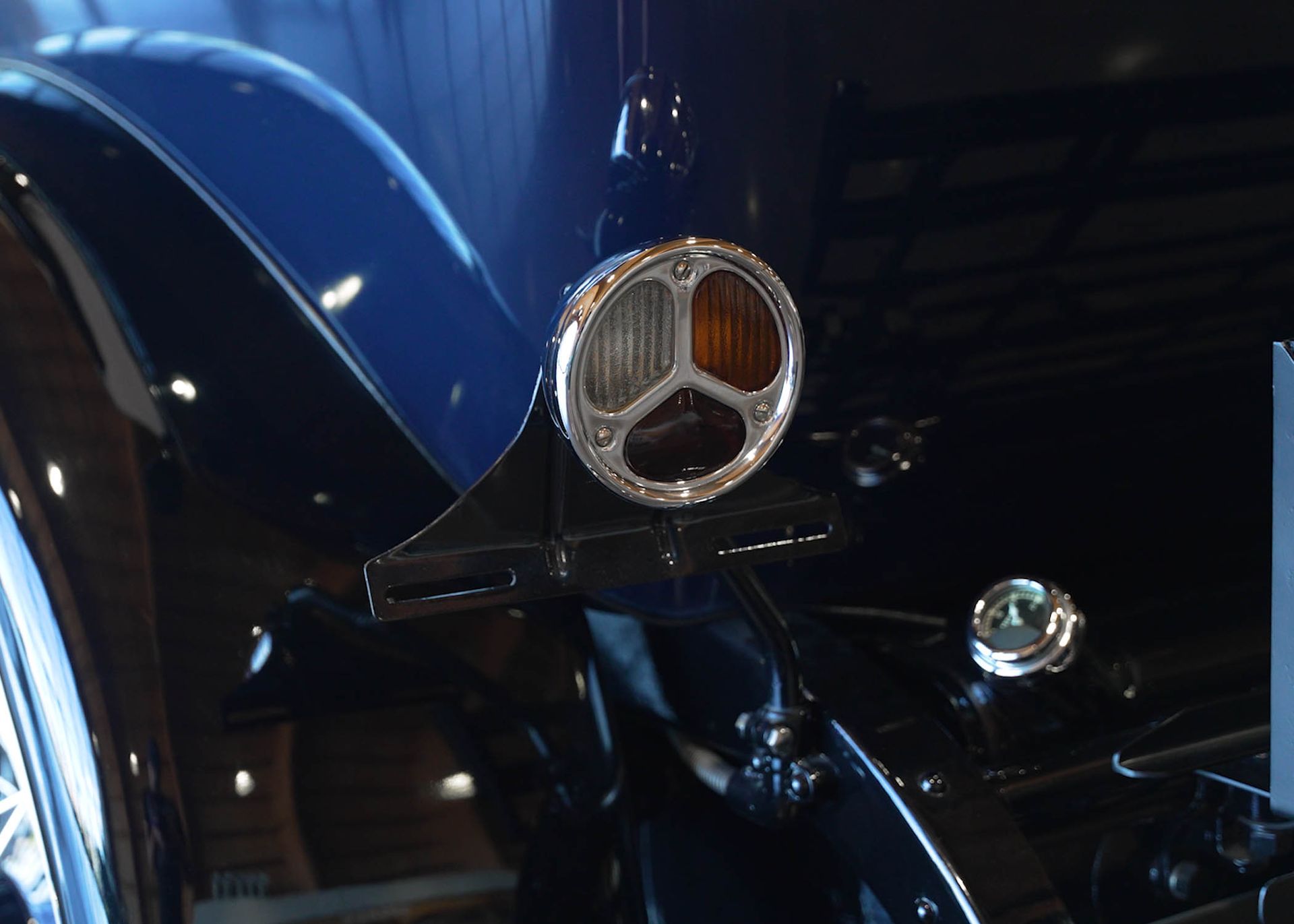 A close up of a car hood with a light on it