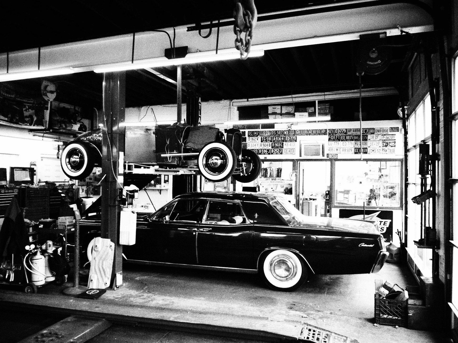 a hot rod and classic car in a garage