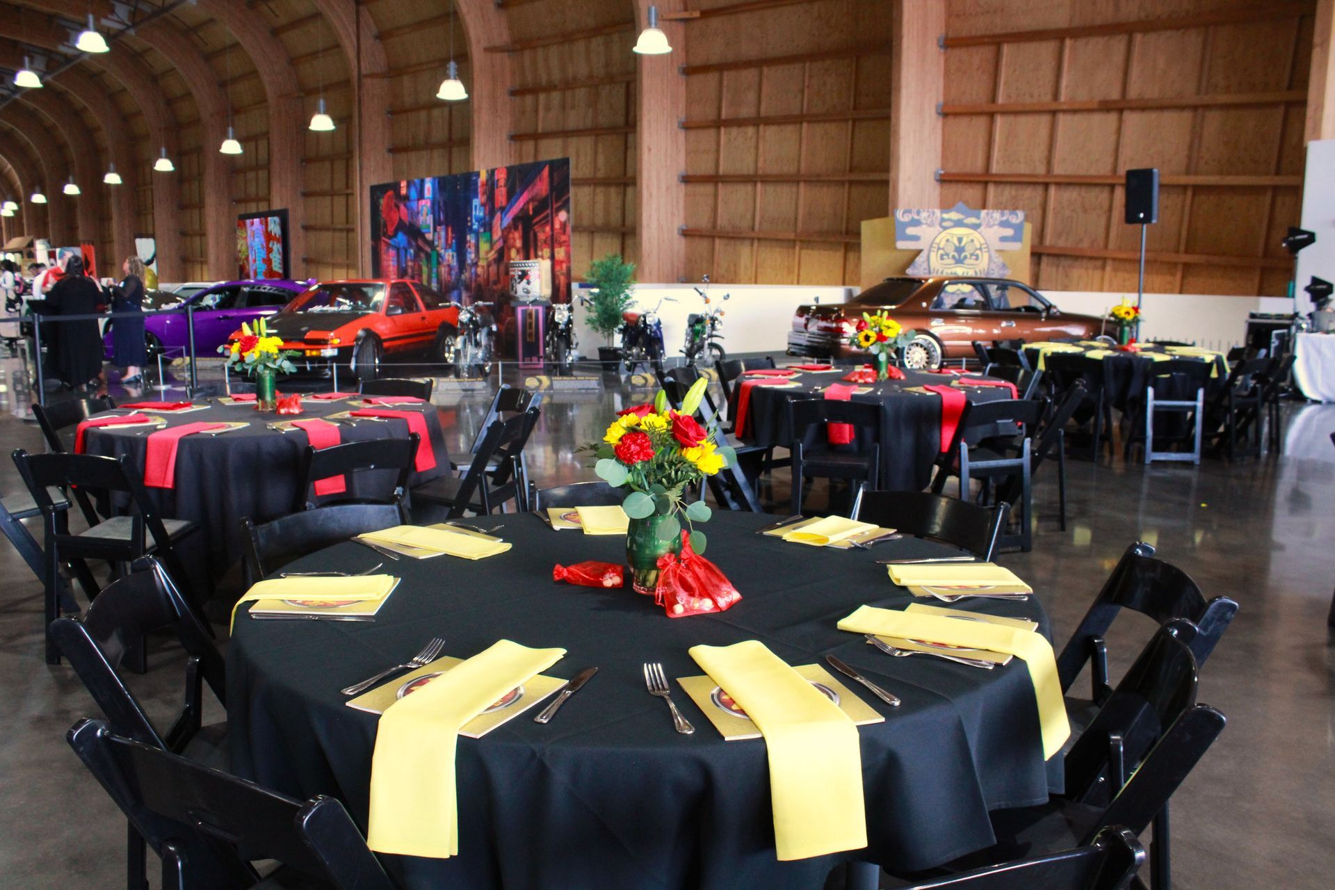 A large room with tables and chairs set up for a party