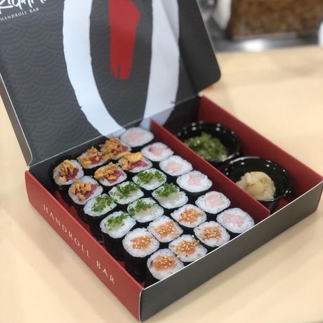 a box of sushi with a red label that says handroll bar