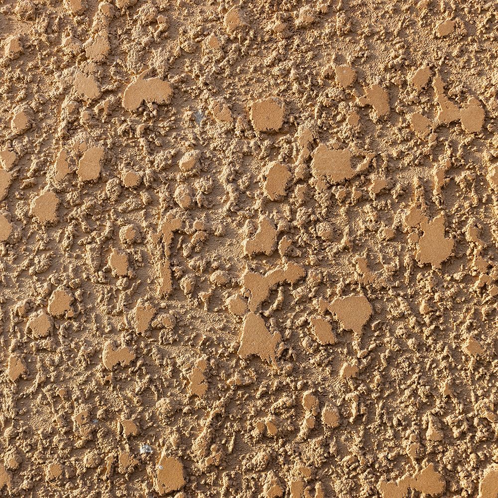 A close up of a brown wall with a rough texture