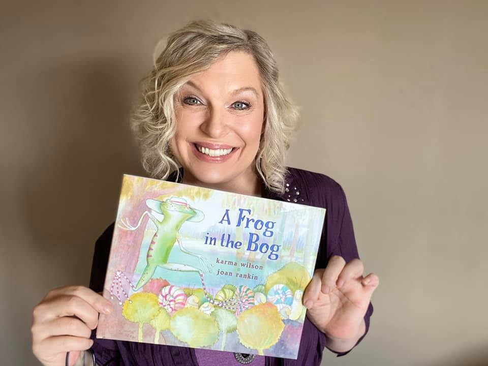 Author Karma Wilson holding Frog in the Bog book