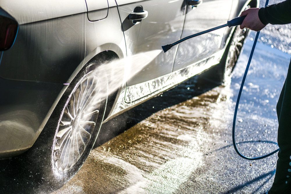 A Person Is Washing a Car with A High Pressure Washer — Junction Car Wash Mordialloc In Mordialloc, VIC