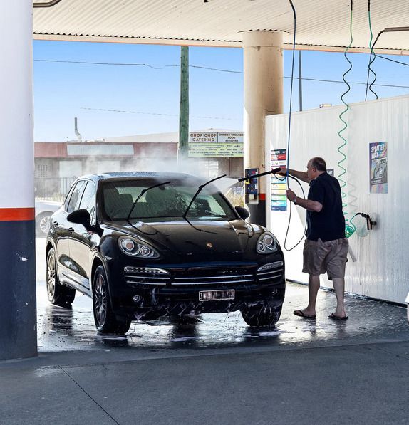 A Car Is Being Washed with A High Pressure Washer — Junction Car Wash Mordialloc In Mordialloc, VIC