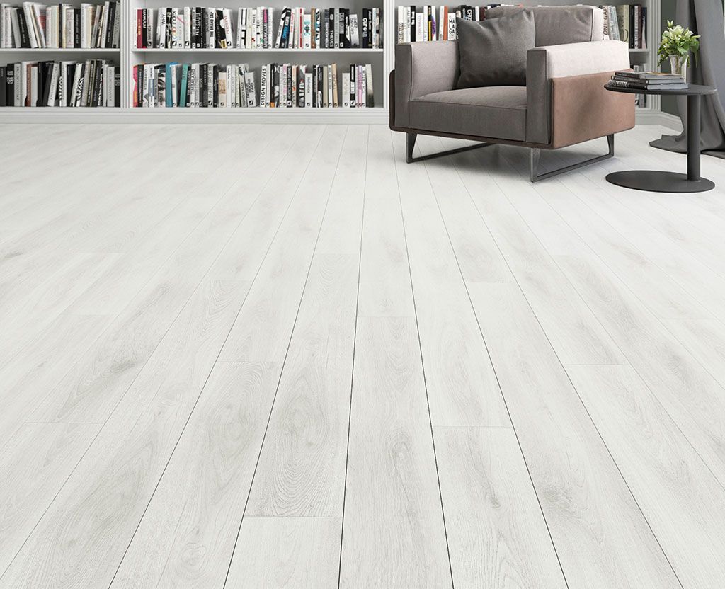 A living room with hardwood floors , a couch , chairs , and a coffee table.