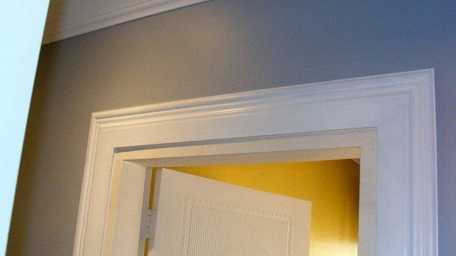 A close up of a door with the door open in a room.