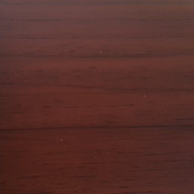 A close up of a piece of dark wood.