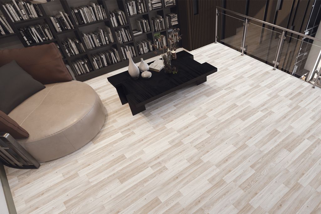 A living room with hardwood floors , a couch , chairs , and a coffee table.