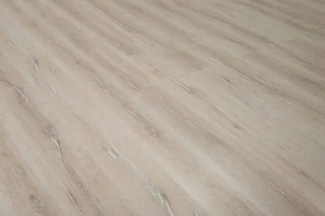 A close up of a white wooden floor in a room.