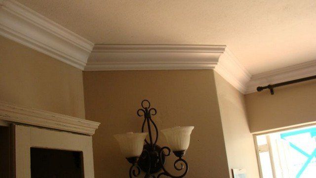 A chandelier is hanging from the ceiling in a living room