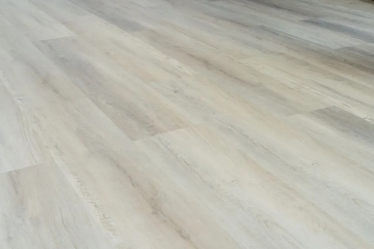 A close up of a white wooden floor in a room.