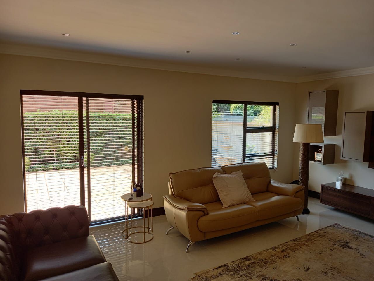 A living room with a couch and chairs and a sliding glass door